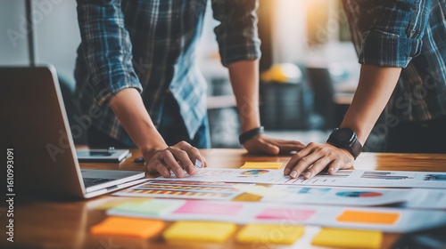 Team analyzes data on table. Business partners collaborate, plan strategy. Workplace. Marketing, web, design, editorial use.