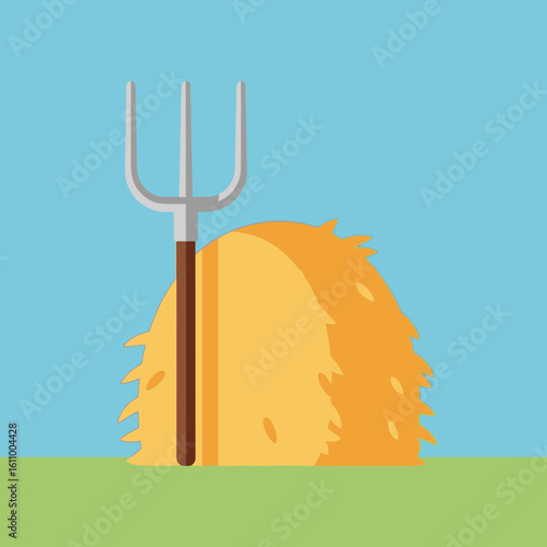 Hay bale with pitchfork on green grass against a blue sky background.