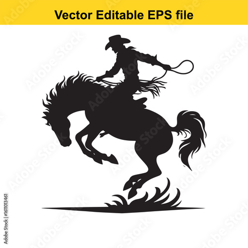 Silhouette of a cowboy riding a bucking horse with a lasso