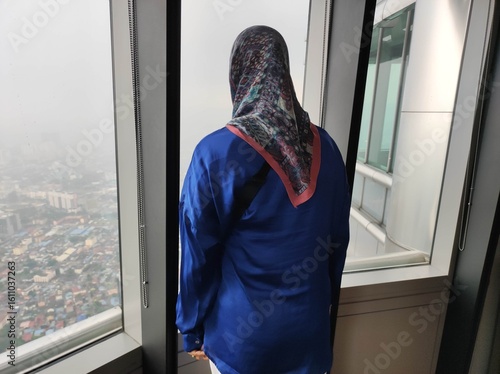 Photography Muslim Woman Admiring Hazy Kuala Lumpur Skyline from High Vantage Point