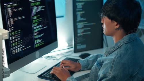 Close up software developer typing code debugging system on multi monitor setup for programming and application development