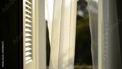Gentle Breeze Causing White Curtains to Billow and Wave