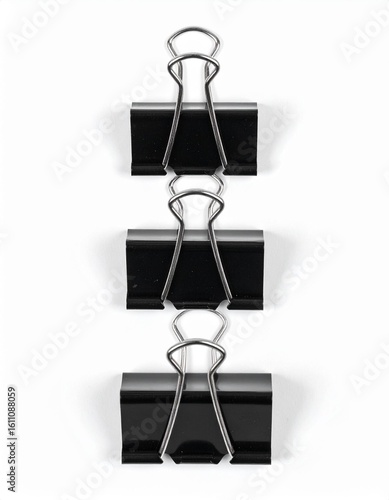 A creative arrangement of black binder clips stacked vertically for an appealing office or organizational concept.