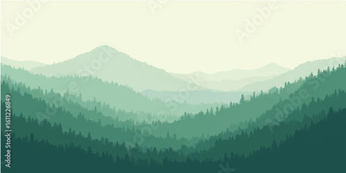 Morning mountain landscape with fog and clouds over forested hills and valley at sunrise