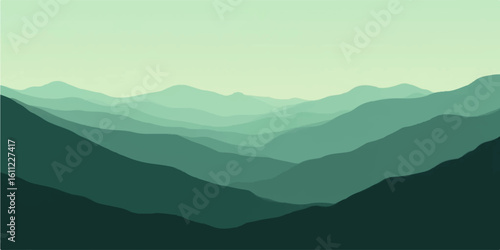 Majestic mountain landscape at sunrise, with misty valleys and a vibrant blue sky