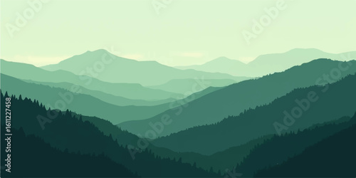 Misty morning view of a mountain landscape with fog-covered peaks and a dramatic sky