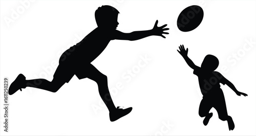 Silhouette of a two boys playing catch with a football in a park on a sunny day, demonstrating active family fun and outdoor recreation