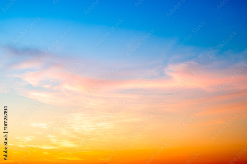 Obraz premium Beautiful , luxury soft gradient orange gold clouds and sunlight on the blue sky perfect for the background, take in evening,Twilight, Large size, high definition landscape photo