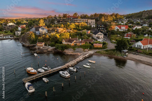 beautiful areal view of typical norwegian village from above with luxury villas sea fishermen's houses and boats. 
fishing village