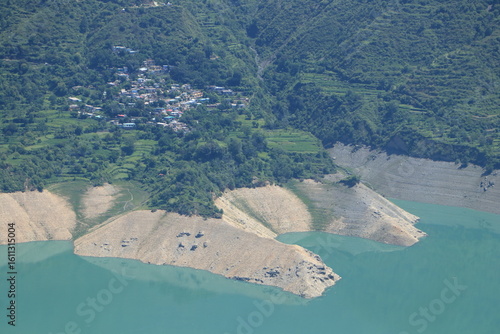 Tehri Lake, nestled in the Garhwal Himalayas of Uttarakhand, is a stunning man-made reservoir created by the Tehri Dam. Surrounded by lush green hills and snow-capped peaks.