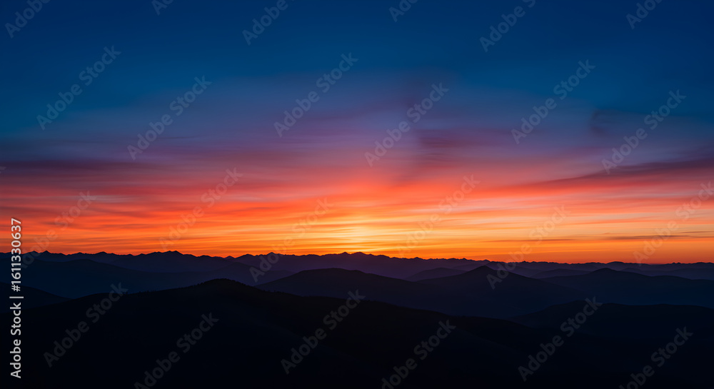 Obraz premium Vibrant Sunset over Misty Mountain Range