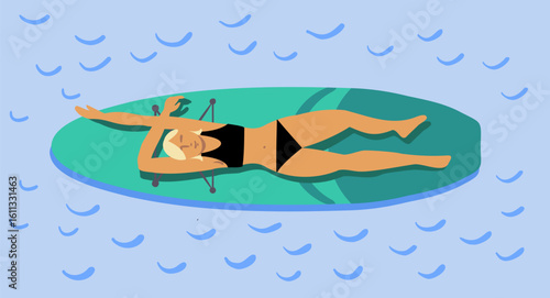 The girl is lying on a paddle board, swimming and relaxing on the water.
