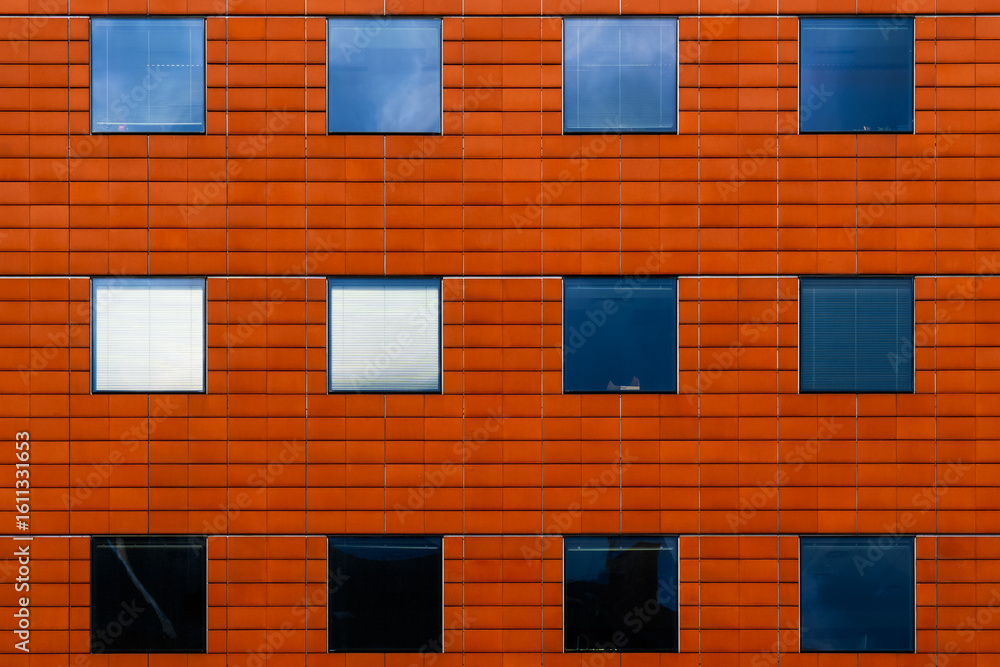 Fototapeta premium Residential building facade with terracotta cladding and evenly spaced windows