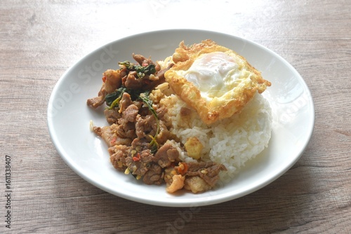 Wall Mural spicy stir fried slice beef meat with basil leaf and chili on rice topping egg i