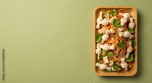 Gourmet Fried Chicken Bites with Sesame Seeds and Greens on Wooden Tray