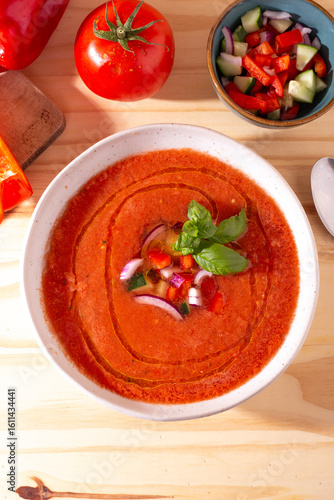 Fresh tomato and bell pepper gazpacho with basil and onion — overhead, natural light.CR2+JPEG