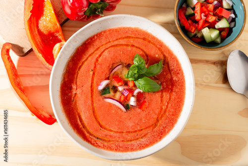 Fresh tomato and bell pepper gazpacho with basil and onion — overhead, natural light.CR2+JPEG