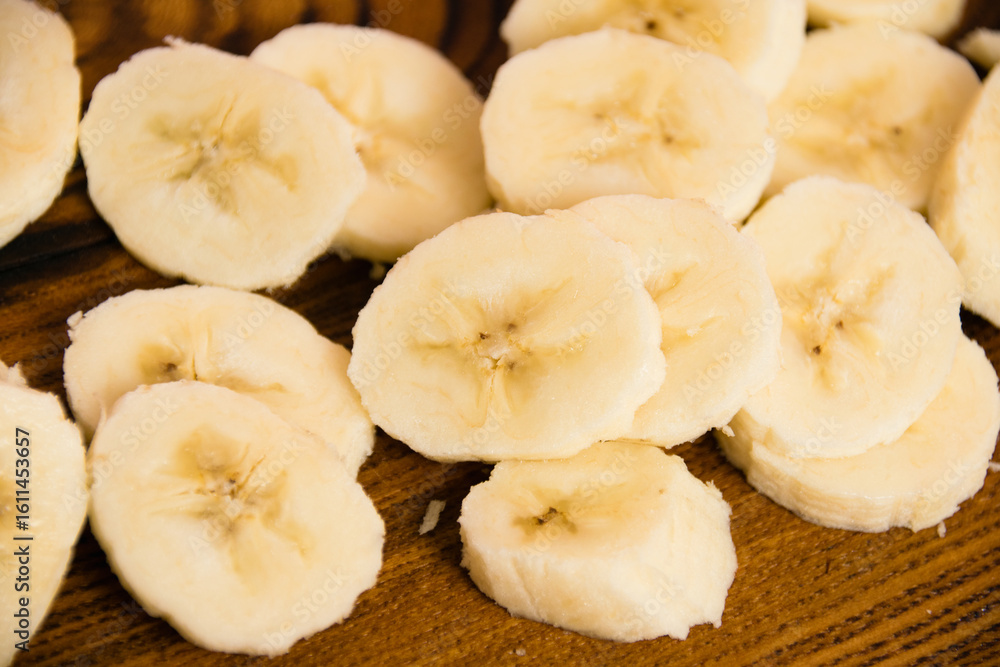 Banana slices on a dark wooden background Banana slices on a dark wooden background