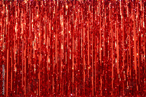 A close up of a red glitter curtain