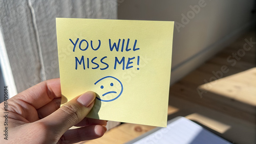 “YOU WILL MISS ME!” Handwritten Note with Sad Face – Emotional Farewell Gesture on Wooden Floor