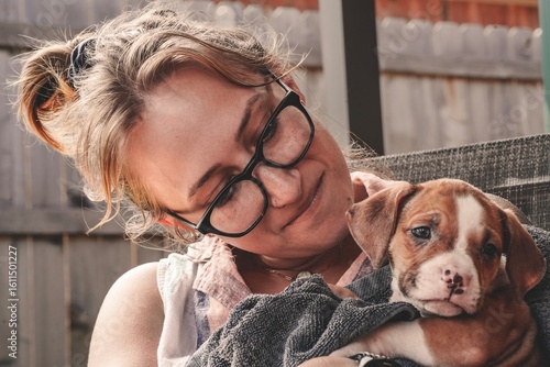 A woman and her new puppy bond