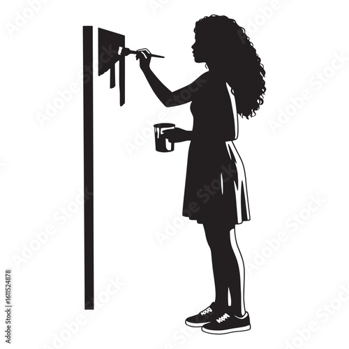 Silhouette of a young woman painting on a wall with a brush and paint container