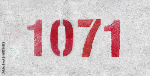 Red Number 1071 on the white wall. Spray paint.