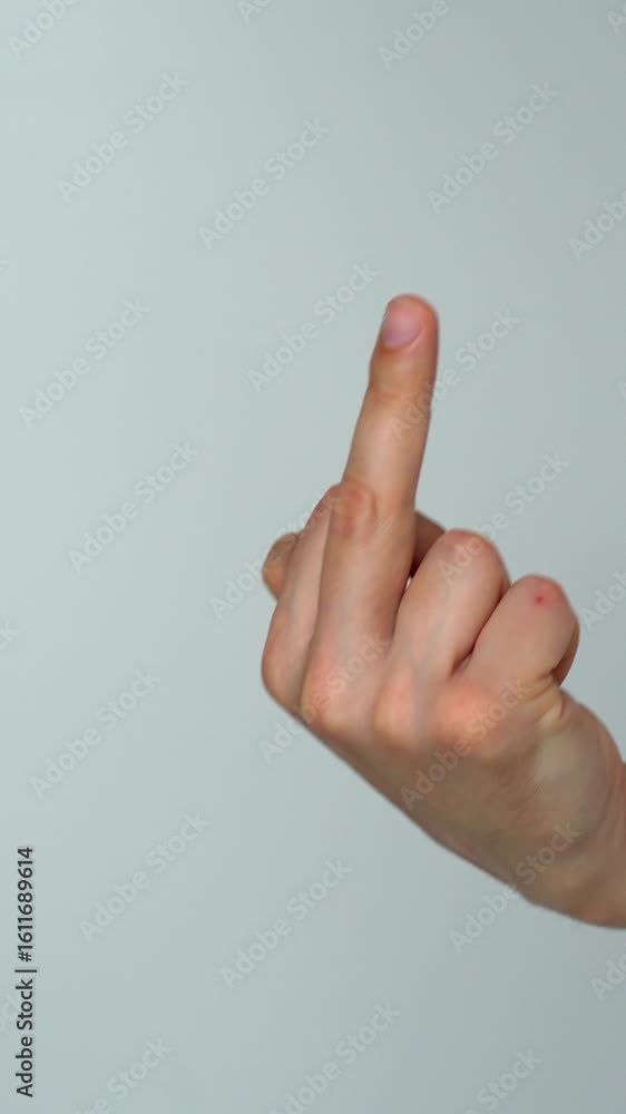 An angry man raises his middle finger up and shows it to someone in anger.
Insult and negativity.
Middle finger on a gray background in the studio.
Gesture of conflict and aggression An angry man raises his middle finger up and shows it to someone in anger.
Insult and negativity.
Middle finger on a gray background in the studio.
Gesture of conflict and aggression