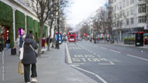 Wallpaper Mural Blurred people walking on a winter street in london with iconic red buses, capturing the essence of urban life in the uk capital on a cold day. Torontodigital.ca