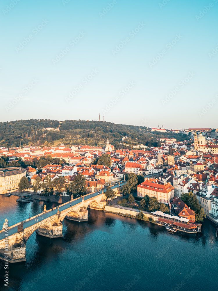 Morning light bathes Prague in golden hues, showcasing a stunning aerial view of the historic city. Morning light bathes Prague in golden hues, showcasing a stunning aerial view of the historic city.