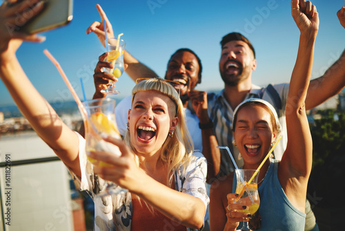 Photography Group of cheerful multi-ethnic friends taking selfie and having fun at rooftop p