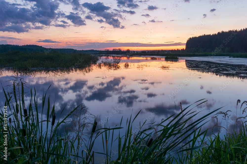 Obraz premium sunrise over the lake with reflections clouds in the water