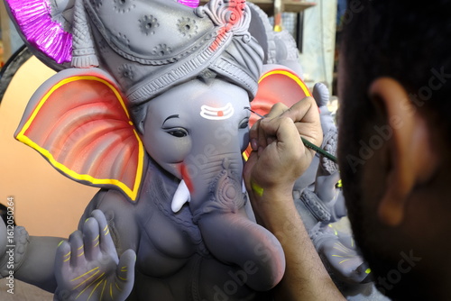 Artist paints an Idol of Lord 