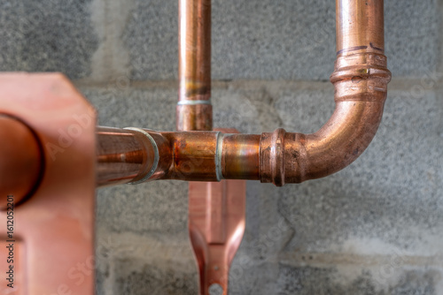 Combination soldered and press-fit fittings, copper pipe plumbing connections and fittings for new potable water pipes in a bathroom.