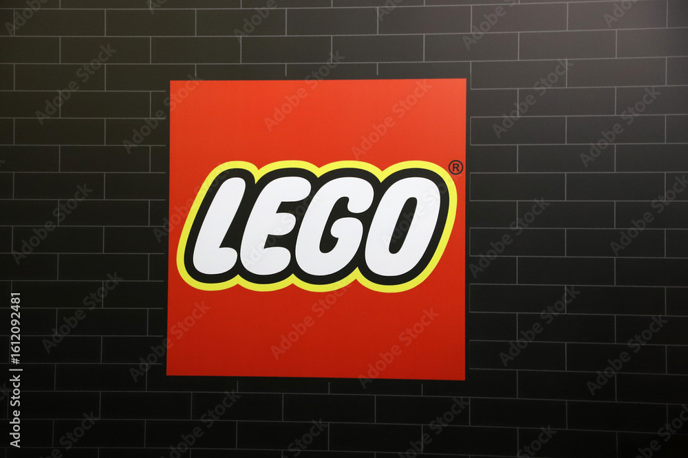 Obraz premium Isolated logo of the Lego toy block brand on a black brick background