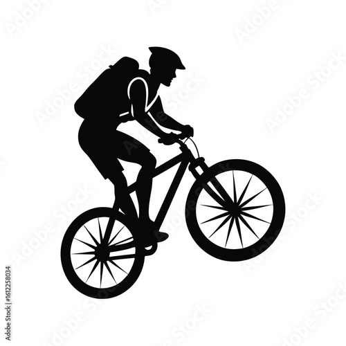 Mountain biker performing wheelie silhouette