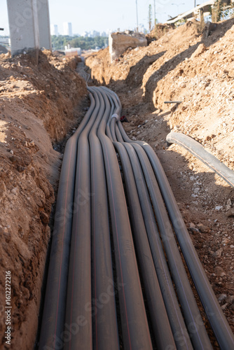 Digital telecommunication network pipes hold cables buried underground. Many electric and high-speed network lines are placed on a construction site in israel