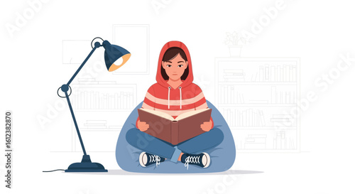 Young Woman Reading A Book Relaxing On A Beanbag At Home