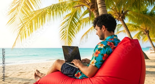 man with laptop on the beach