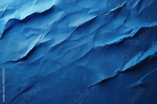 Wallpaper Mural Close-up of crumpled blue paper with torn edges and textured surface showing gradient of blue shades Torontodigital.ca