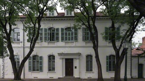 Wallpaper Mural A white twostory building with green shutters framed by trees Torontodigital.ca