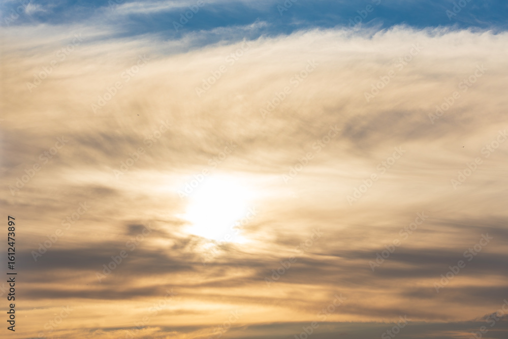 Fototapeta premium Warm Evening Light Filtering Through Soft Clouds.