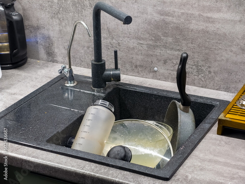 Dirty Dishes in a Modern Kitchen Sink