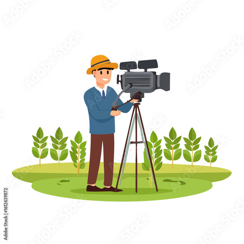 Man in hat operating professional video camera on tripod in grassy field.