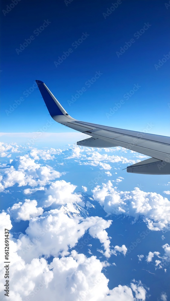 Fototapeta premium Airplane wing view of clouds and sky