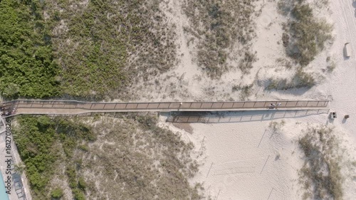 Wallpaper Mural Aerial top-down view of a long boardwalk stretching across the dunes, leading beachgoers to the shore. Torontodigital.ca