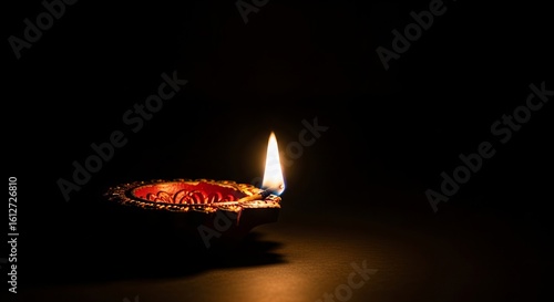 Illuminated diya flame light dark