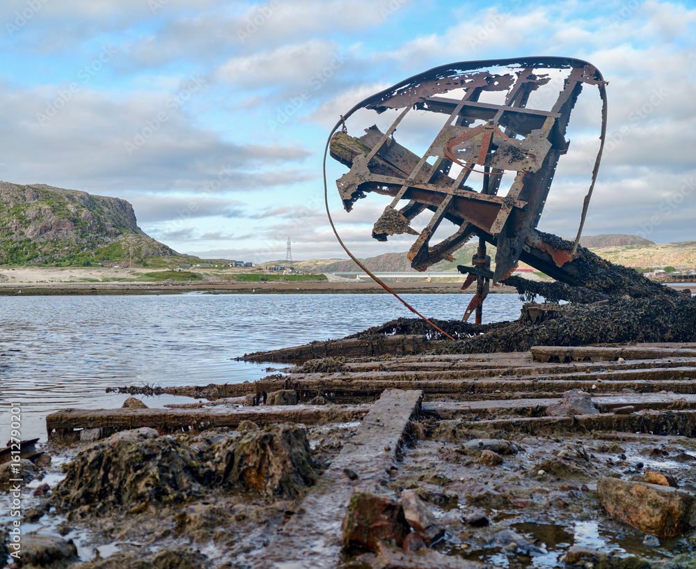 Fototapeta premium old abandoned sunken ship in the water at the ship cemetery