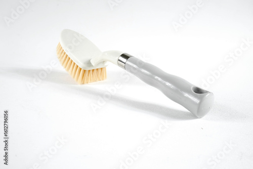 Hard bristle cleaning brush with long blue handle and ergonomic gray grip, isolated on white background
