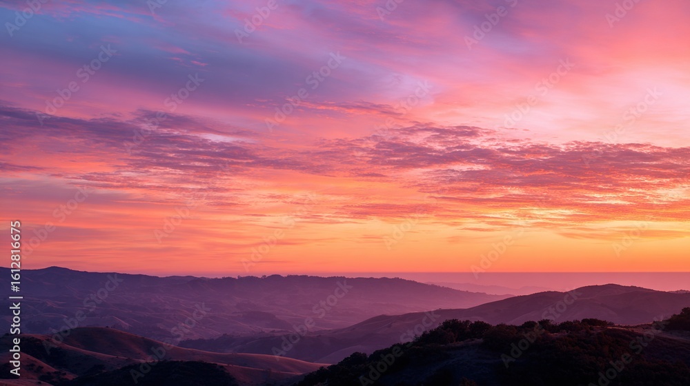 Fototapeta premium Pink And Orange Sunset Over Rolling Hills Silhouette. High quality